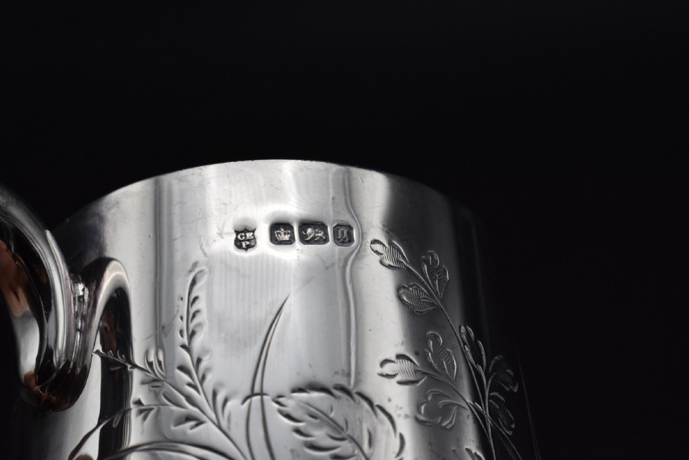 A late Victorian sterling silver tankard featuring etched floral motifs and British hallmarks near the top rim. View XIII