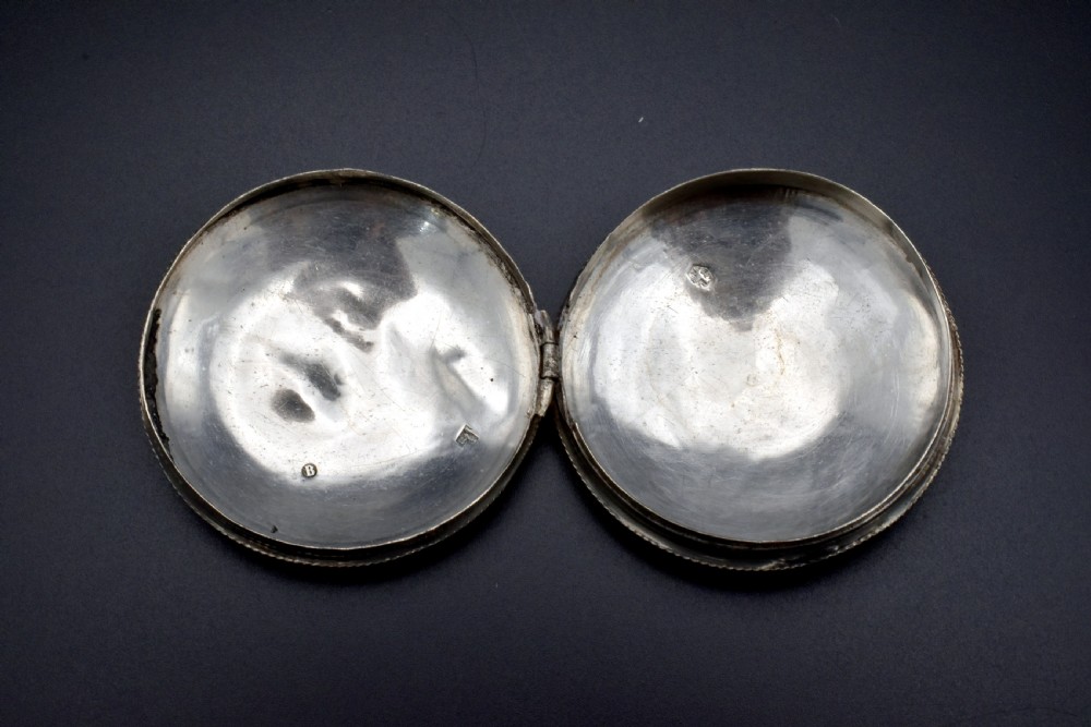 A circular 19th-century Dutch sterling silver snuff box featuring concentric engine-turned engraving and reeded borders. View IV