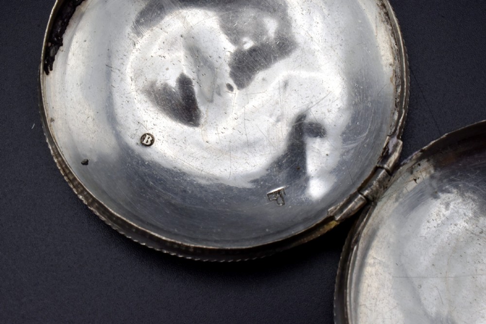 A circular 19th-century Dutch sterling silver snuff box featuring concentric engine-turned engraving and reeded borders. View VI