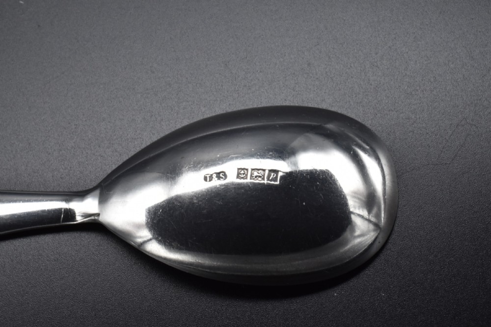 A sterling silver caddy spoon featuring a broad oval scoop bowl and a short flat handle with horizontal line accents. View III