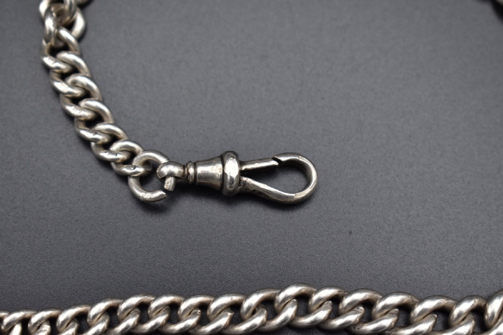 A Victorian sterling silver Albert watch chain featuring heavy curb links, a T-bar fastener, and a swivel clasp. View III