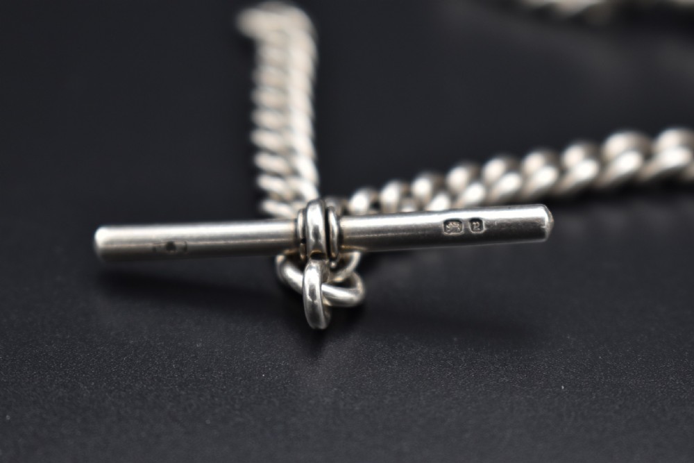 A Victorian sterling silver Albert watch chain featuring heavy curb links, a T-bar fastener, and a swivel clasp. View VI