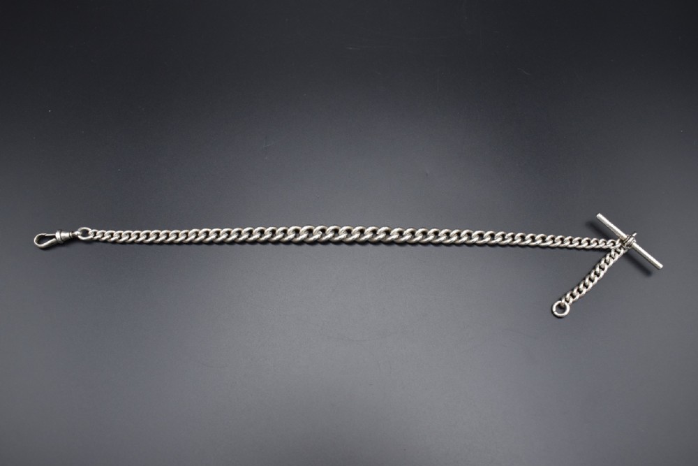A Victorian sterling silver Albert watch chain featuring heavy curb links, a T-bar fastener, and a swivel clasp. View VII