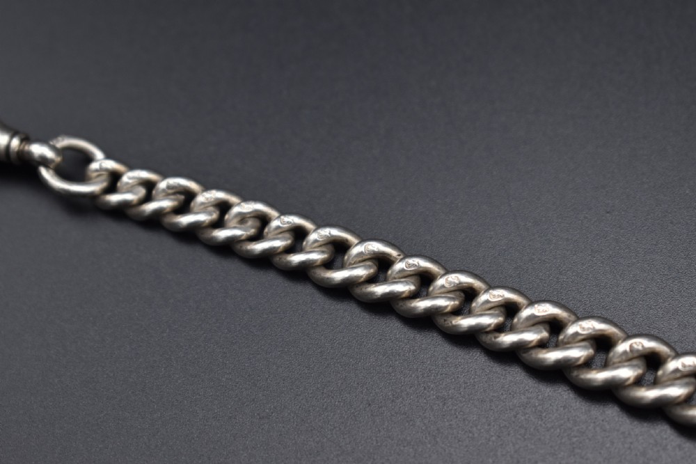 A Victorian sterling silver Albert watch chain featuring heavy curb links, a T-bar fastener, and a swivel clasp. View VIII