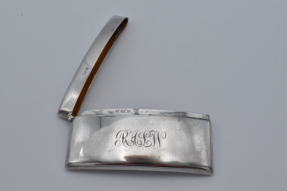 A curved sterling silver card case with hand-engraved monogram initials and visible British hallmarks near the top hinge. View III