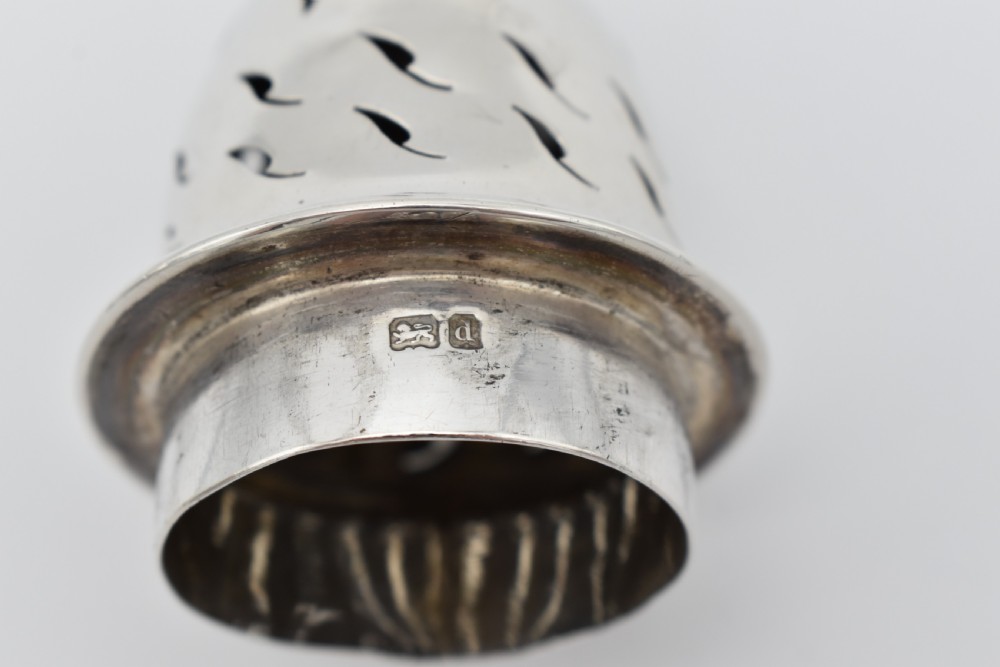 A sterling silver menu holder shaped like a naval crown mounted on an octagonal silver base. View VIII