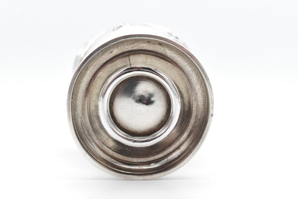 A sterling silver menu holder shaped like a naval crown mounted on an octagonal silver base. View IX