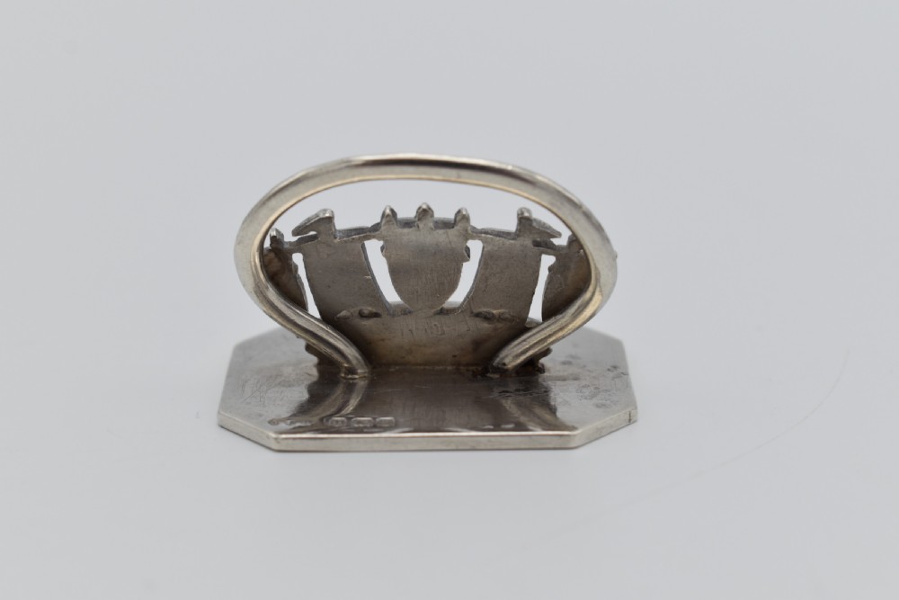 A sterling silver menu holder shaped like a naval crown mounted on an octagonal silver base. View III