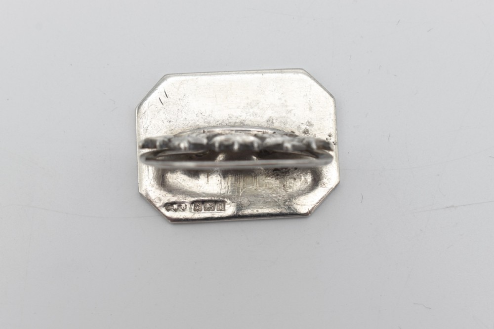A sterling silver menu holder shaped like a naval crown mounted on an octagonal silver base. View V