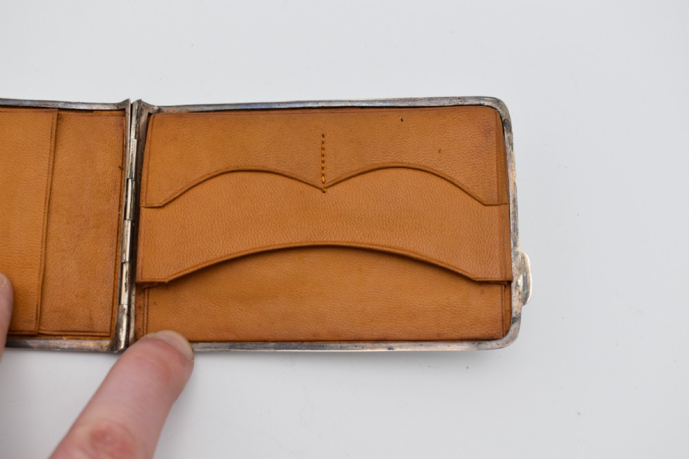 A rectangular sterling silver aide-memoire card case featuring a central hand-engraved cursive monogram M and hallmarks on the lower left corner. View VIII