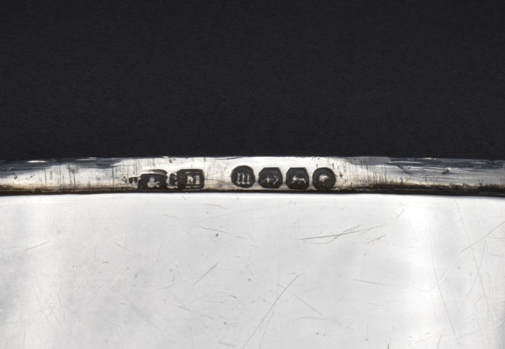 A polished Victorian sterling silver pocket card case with a hinged lid displayed on a dark background. View V