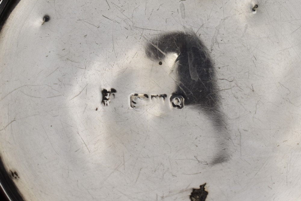 A circular Victorian sterling silver powder box featuring raised repousse scrollwork and foliage on the lid with a smooth cylindrical base. View V