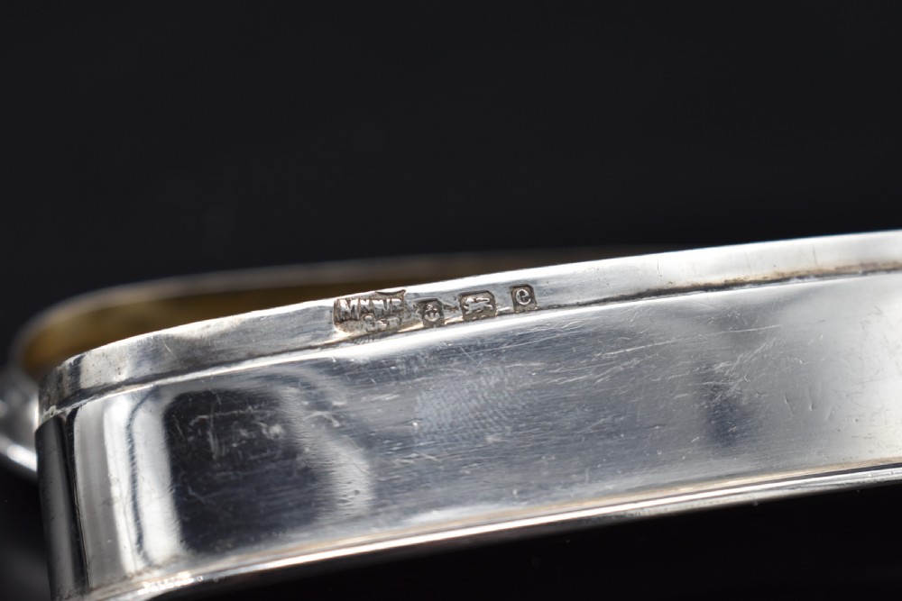 An elongated, oval Edwardian sterling silver powder box featuring engine-turned engraving on the lid and an unengraved central cartouche. View VIII