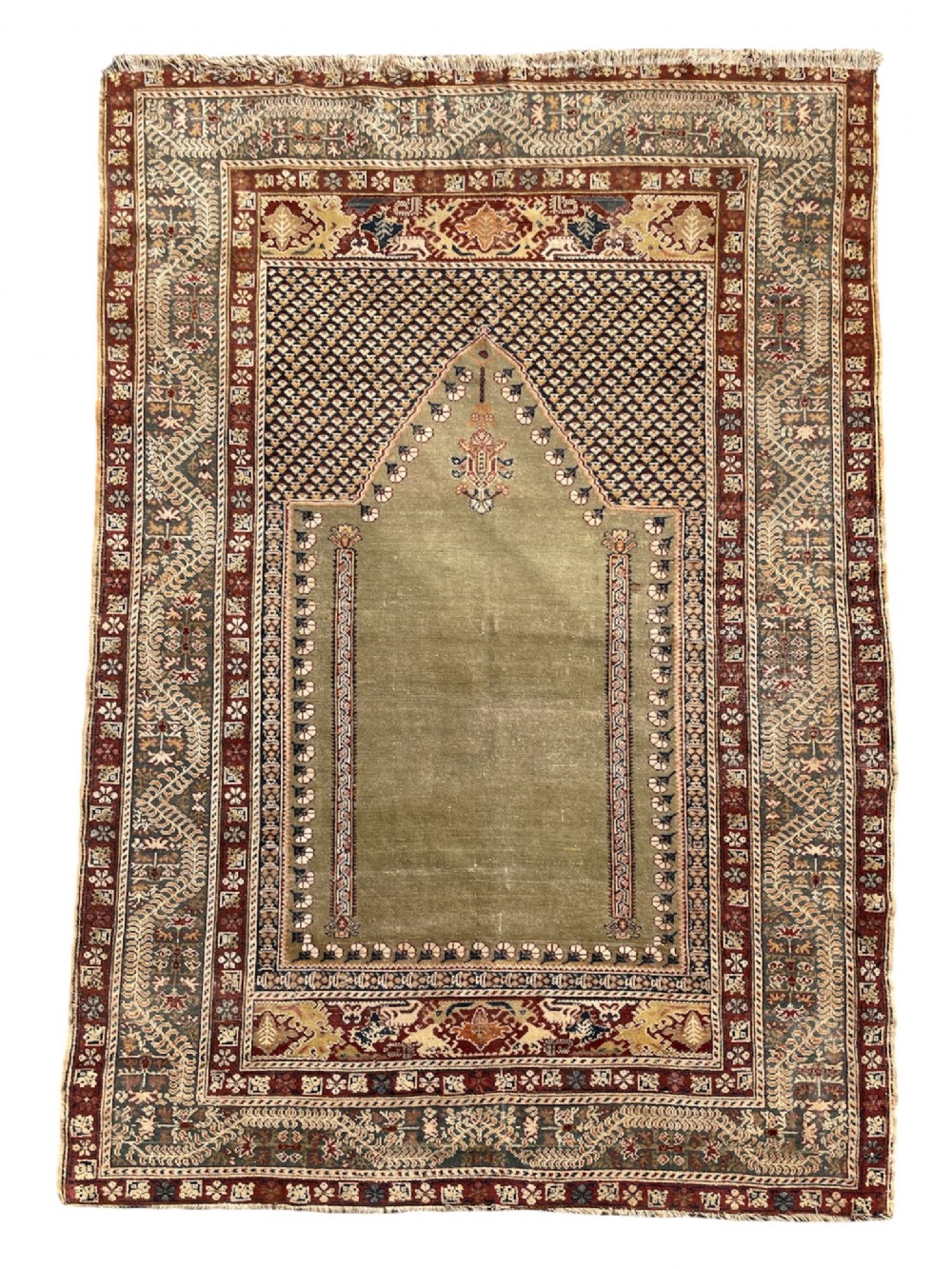An antique hand-knotted Anatolian Ghiordes prayer rug featuring a central sage green arched niche enclosed by detailed rust red and blue decorative borders. View VIII