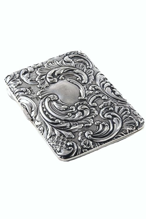 fig 1. An Edwardian sterling silver aide-memoire case featuring repousse scrollwork, leaf motifs, and a central unengraved cartouche.