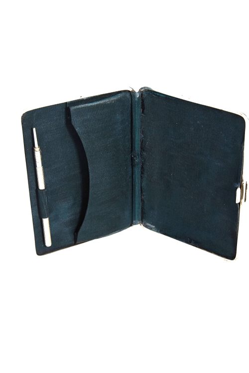 fig 3. An Edwardian sterling silver aide-memoire case featuring repousse scrollwork, leaf motifs, and a central unengraved cartouche.