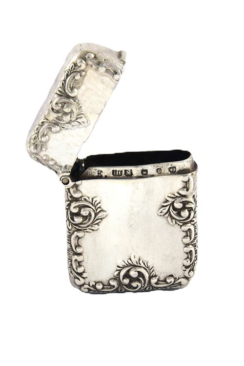 fig 2. A late Victorian sterling silver rectangular vesta case featuring embossed scrollwork decoration and a hinged lid.