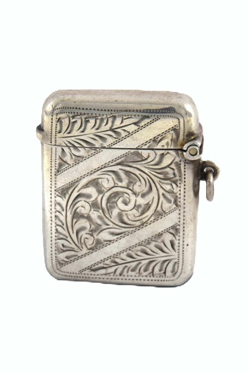 fig 1. A small rectangular George V sterling silver vesta case decorated with hand-engraved foliage motifs, official hallmarks, and a side suspension ring.