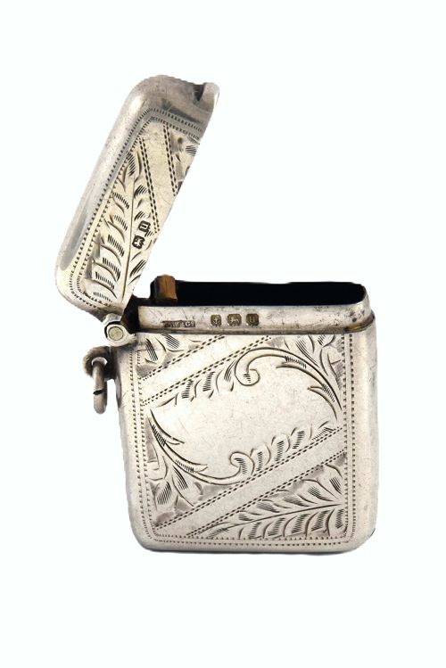 fig 2. A small rectangular George V sterling silver vesta case decorated with hand-engraved foliage motifs, official hallmarks, and a side suspension ring.