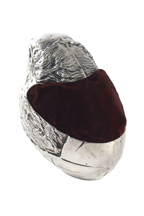 fig 3. An antique sterling silver pin cushion modelled in the realistic form of a chick with detailed feather engraving and a deep burgundy velvet cushion insert.