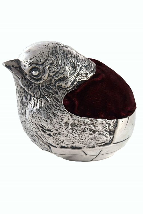 fig 4. An antique sterling silver pin cushion modelled in the realistic form of a chick with detailed feather engraving and a deep burgundy velvet cushion insert.