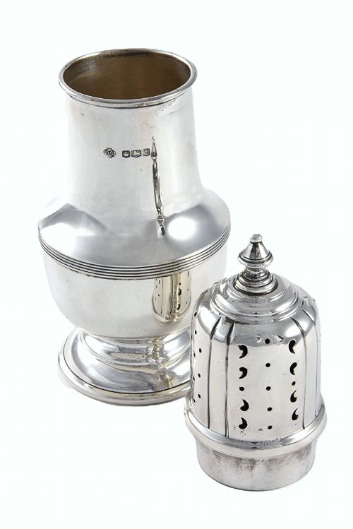 fig 2. A solid sterling silver sugar caster featuring a baluster-shaped body, pierced dome lid with finial, and British hallmarks on the side.
