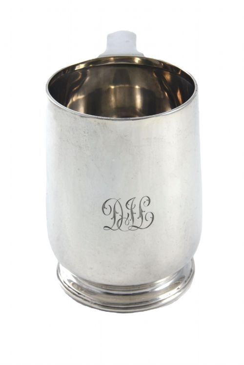 fig 2. A George V sterling silver pint tankard featuring a baluster body, engraved monogram initials, a scroll handle, and a stepped circular foot.