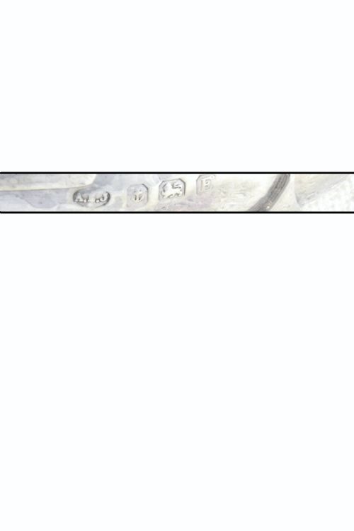 fig 3. A small round George V sterling silver trinket dish featuring twin side handles, planished surface texture, and three small feet.