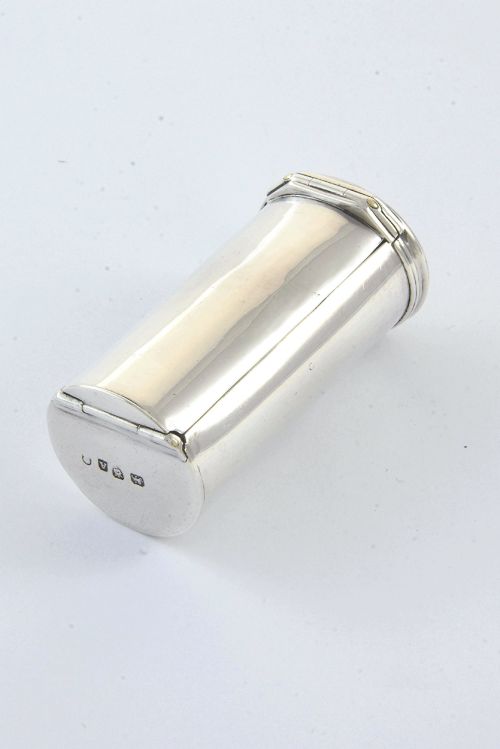 fig 3. A cylindrical Georgian sterling silver nutmeg grater dated 1796 with an engraved crest on the flat top lid.