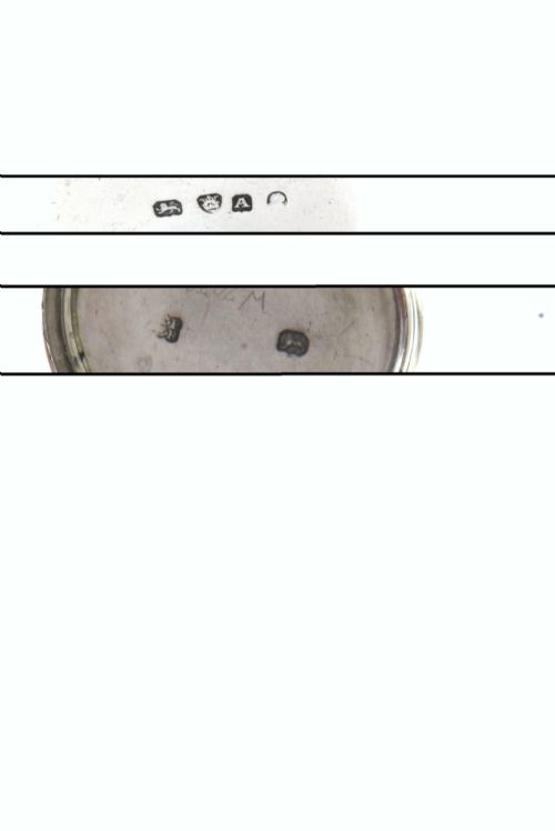 fig 4. A cylindrical Georgian sterling silver nutmeg grater dated 1796 with an engraved crest on the flat top lid.