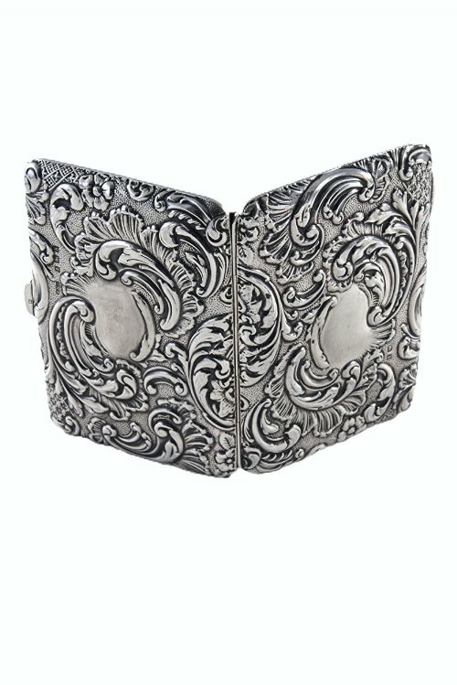 fig 2. An Edwardian sterling silver aide memoire decorated with raised floral repousse scrollwork and a blank central cartouche.