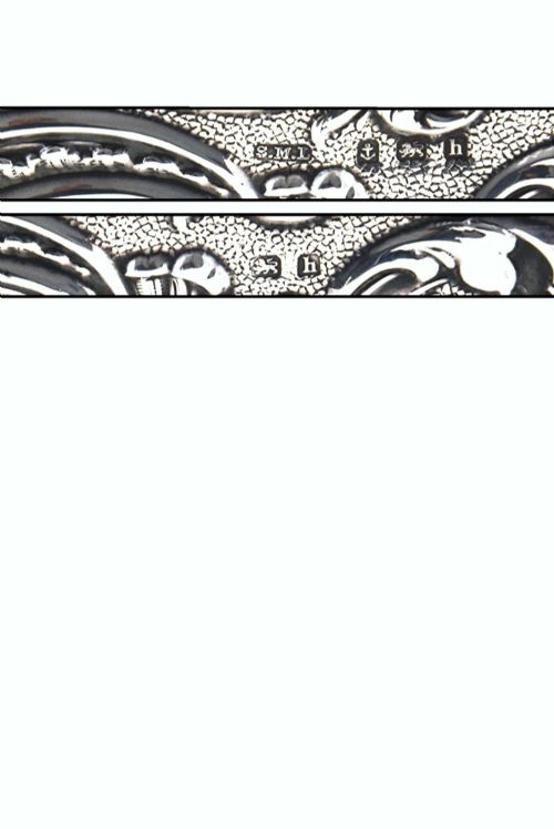 fig 4. An Edwardian sterling silver aide memoire decorated with raised floral repousse scrollwork and a blank central cartouche.