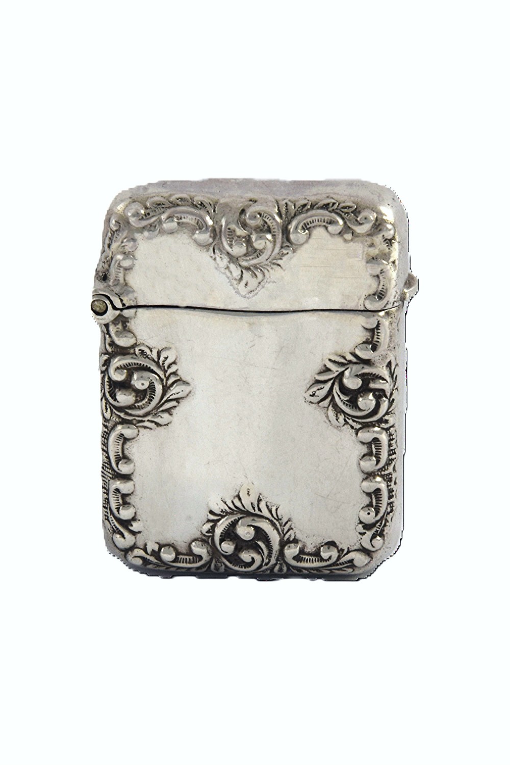A late Victorian sterling silver rectangular vesta case featuring embossed scrollwork decoration and a hinged lid.