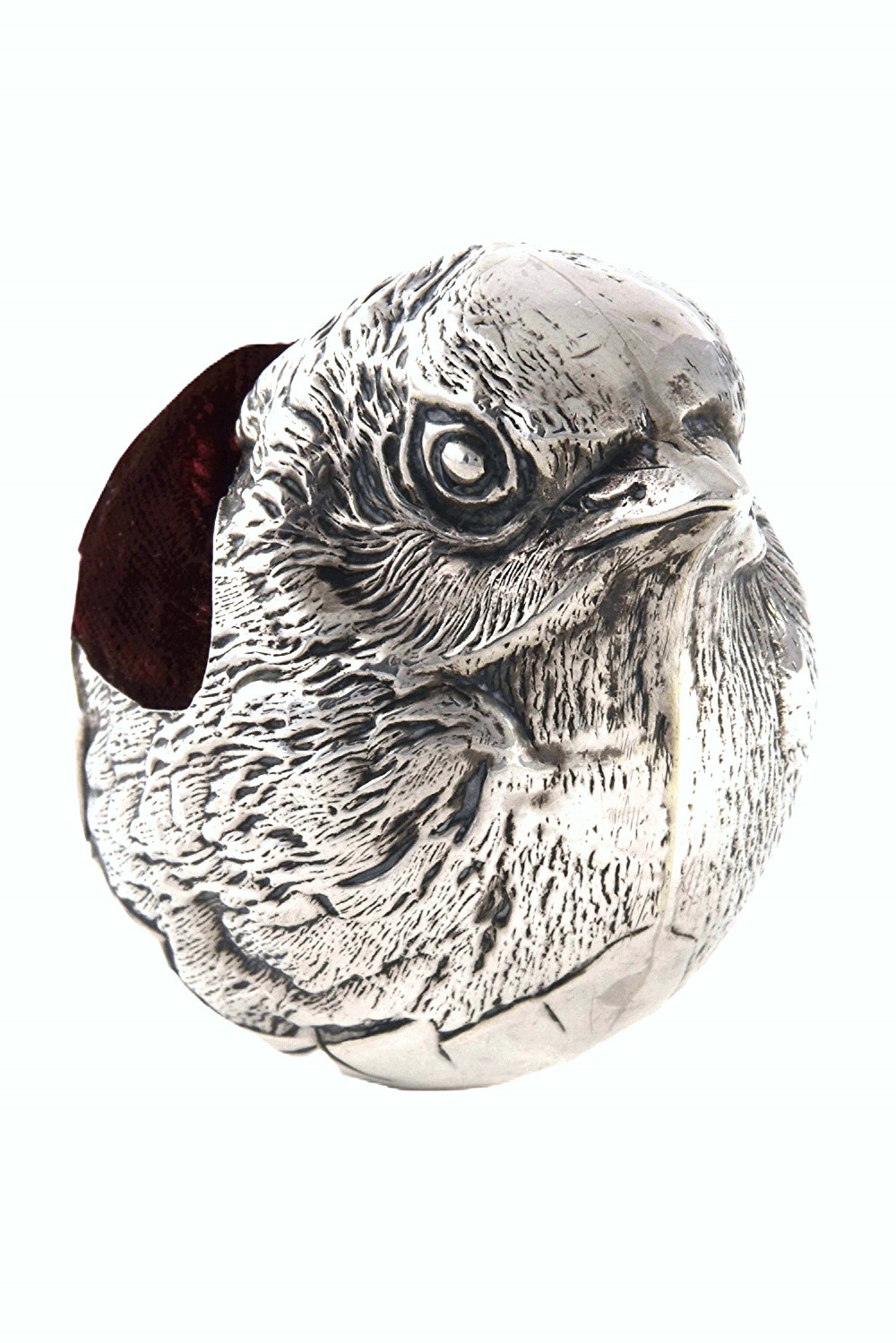 An antique sterling silver pin cushion modelled in the realistic form of a chick with detailed feather engraving and a deep burgundy velvet cushion insert. View II