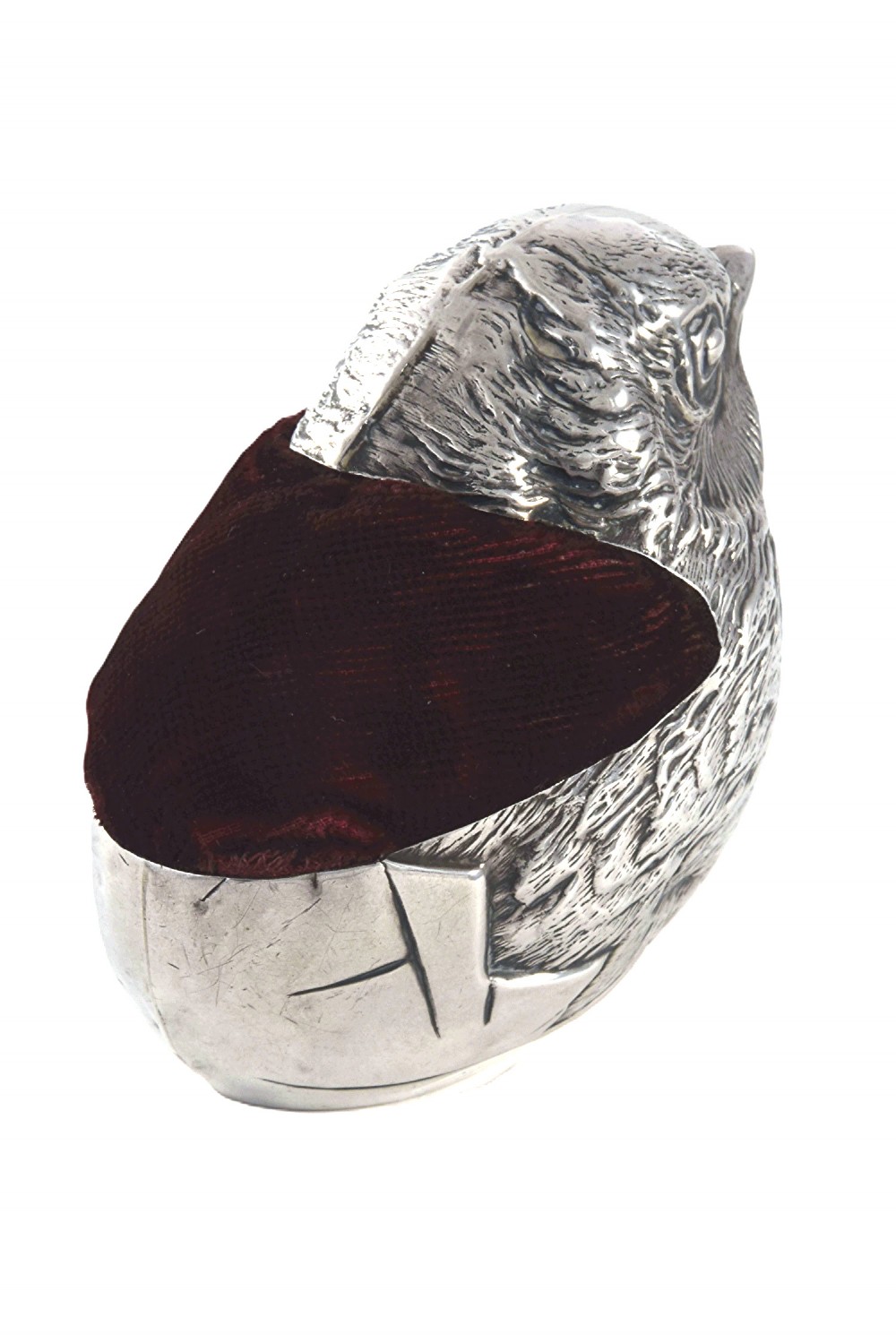An antique sterling silver pin cushion modelled in the realistic form of a chick with detailed feather engraving and a deep burgundy velvet cushion insert. View III