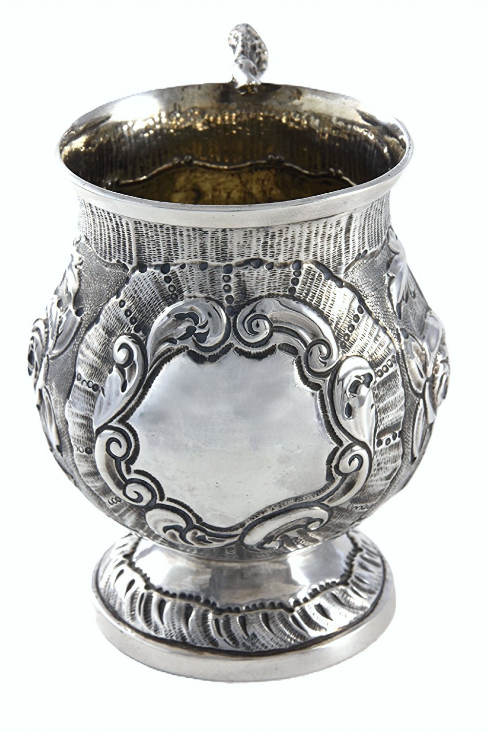 A George IV sterling silver christening mug with floral repousse work, a plain cartouche, and a curved handle set on a stepped base. View III