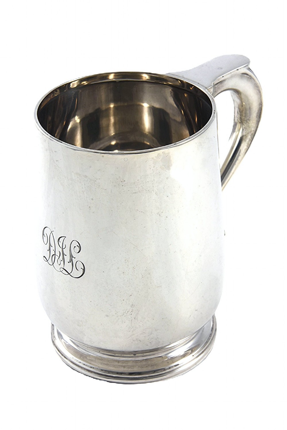 A George V sterling silver pint tankard featuring a baluster body, engraved monogram initials, a scroll handle, and a stepped circular foot.