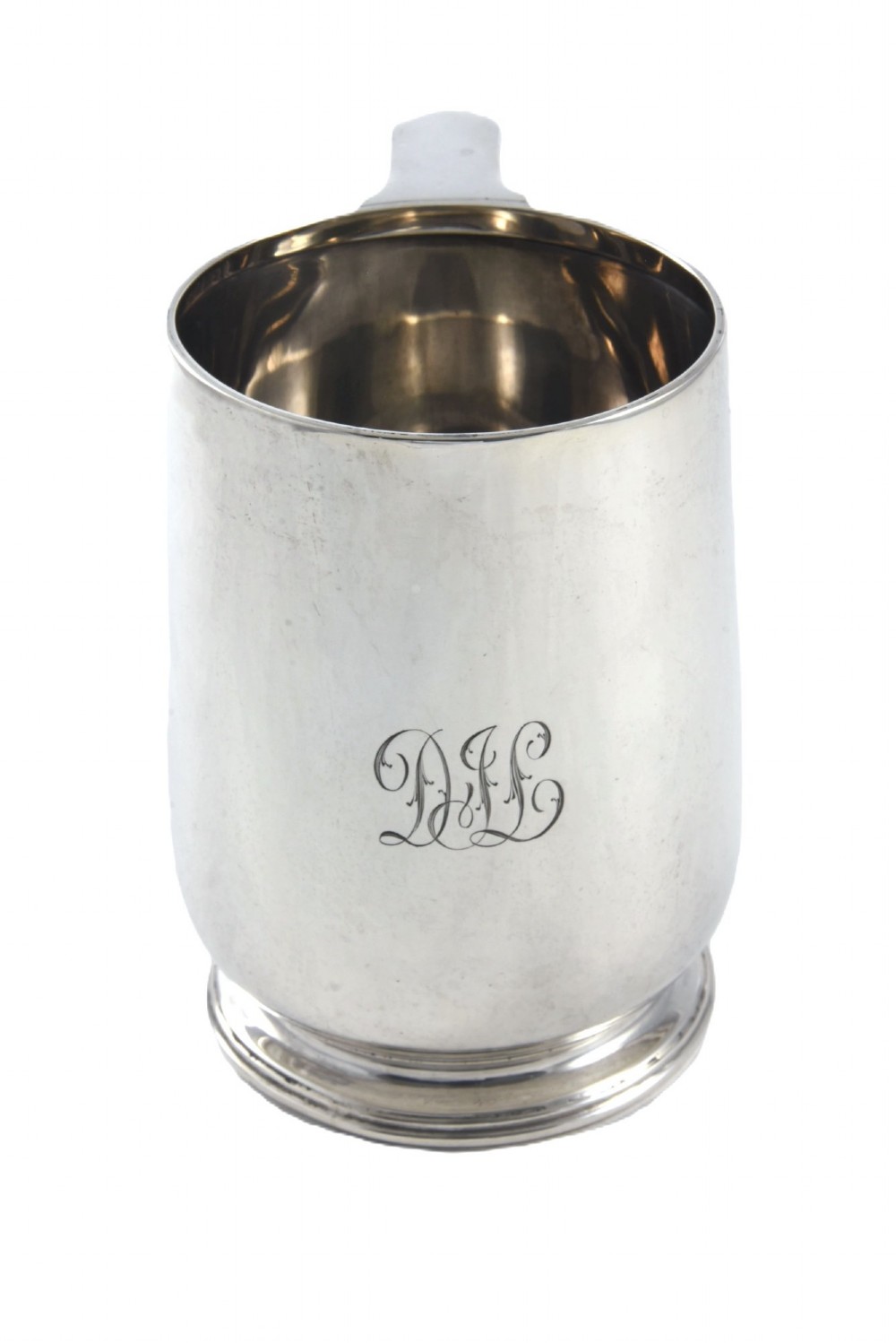 A George V sterling silver pint tankard featuring a baluster body, engraved monogram initials, a scroll handle, and a stepped circular foot. View III