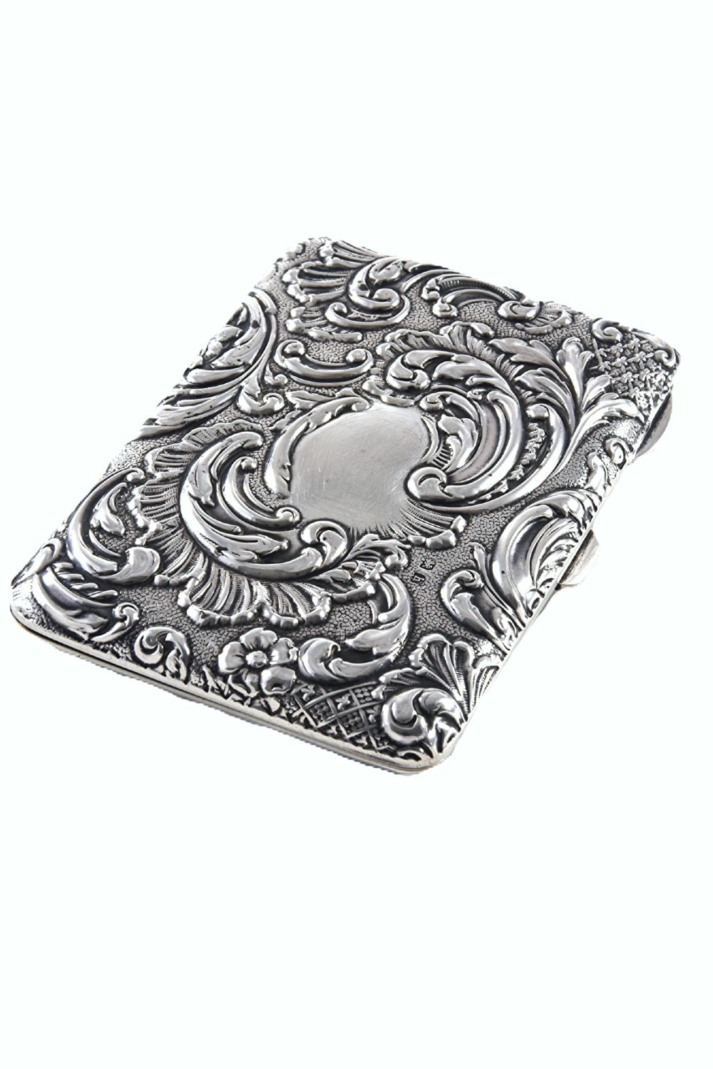 An Edwardian sterling silver aide memoire decorated with raised floral repousse scrollwork and a blank central cartouche.
