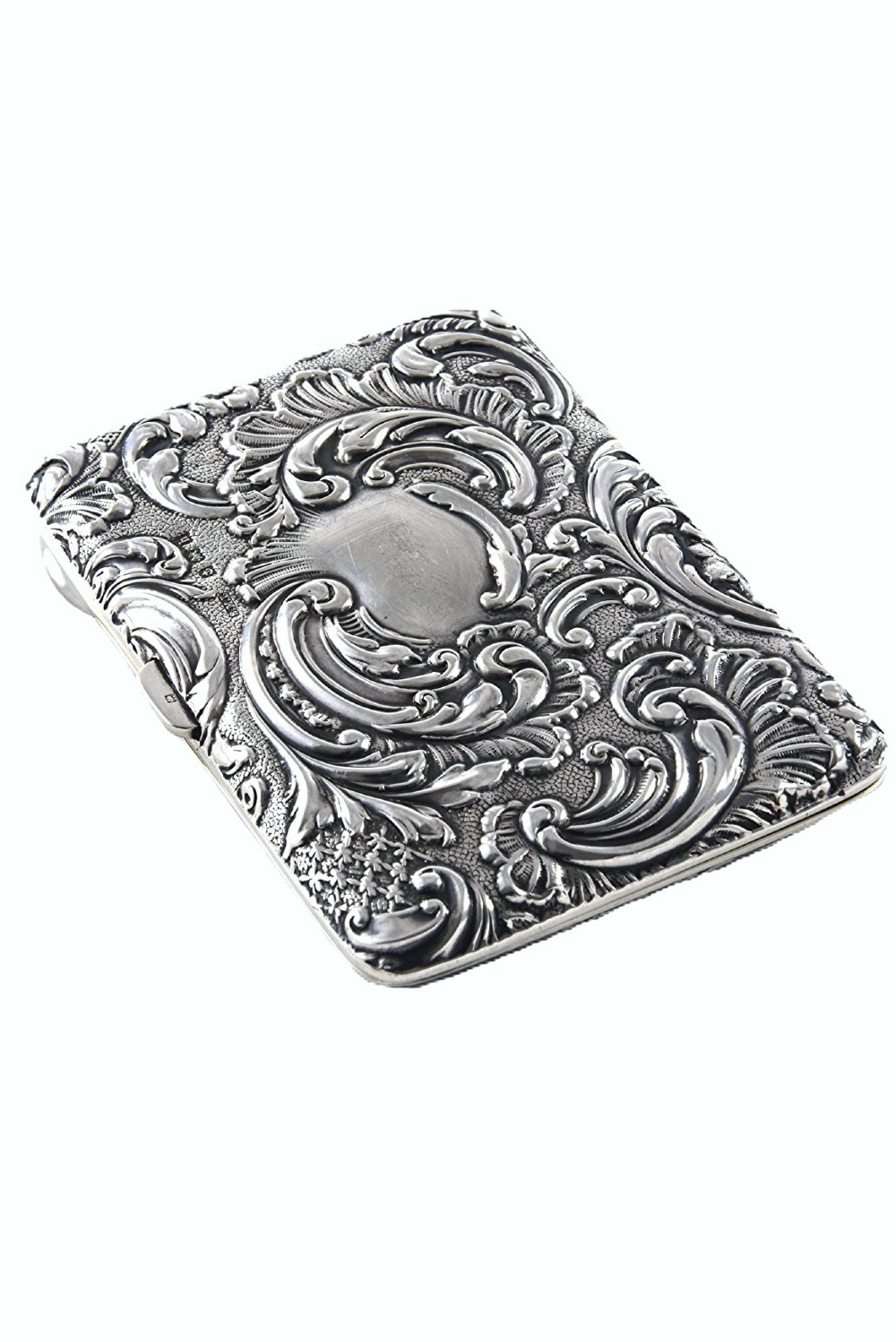 An Edwardian sterling silver aide memoire decorated with raised floral repousse scrollwork and a blank central cartouche. View II