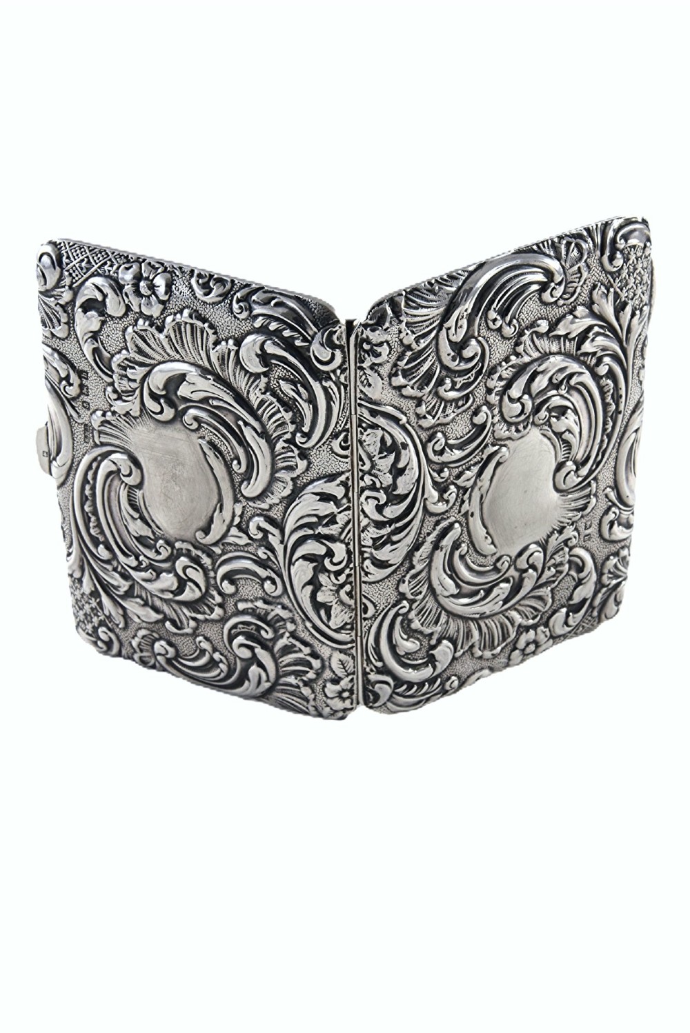 An Edwardian sterling silver aide memoire decorated with raised floral repousse scrollwork and a blank central cartouche. View III