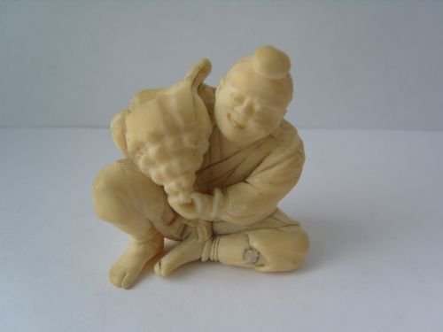 Unusual Japanese Ivory Okimono Carving of a Man Holding a Conch Shell