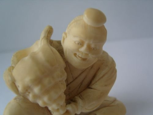 fig 1. Unusual Japanese Ivory Okimono Carving Of A Man Holding A Conch Shell