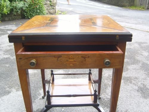 fig 2. An Edwardian inlaid rosewood envelope card table
An Edwardian inlaid rosewood envelope card table
An Edwardian inlaid rosewood envelope card table
Edwardian Inlaid Rosewood Envelope Card Table