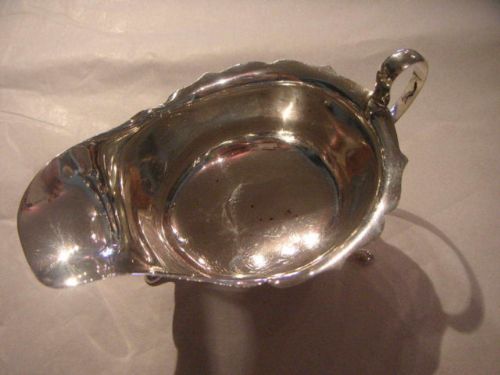 fig 1. SILVER SAUCE BOAT WITH SCALLOPED EDGE ON THREE FEET BY VINERS 1937