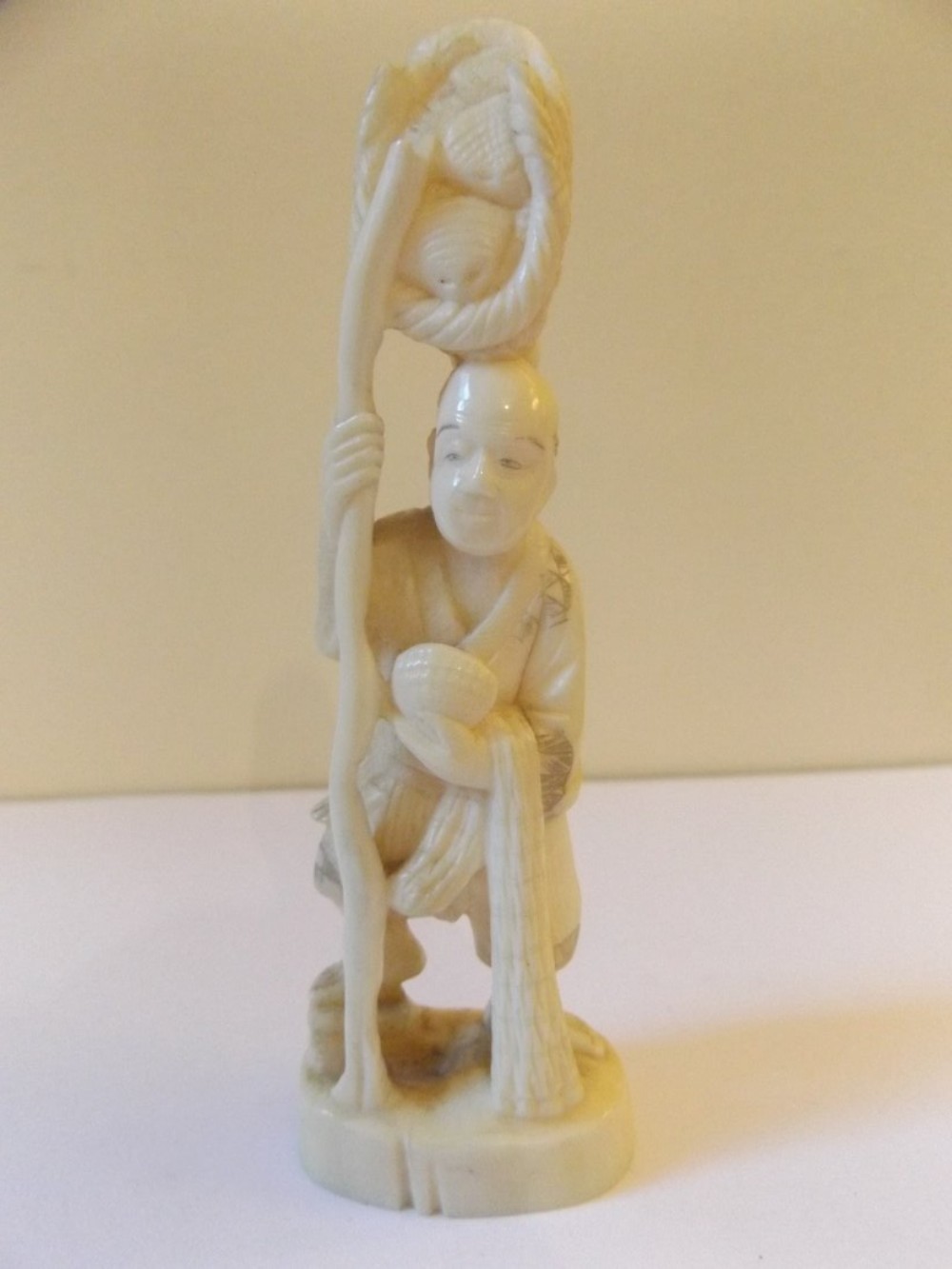 Japanese Ivory Okimono Of a Man Carrying Baskets c1900
