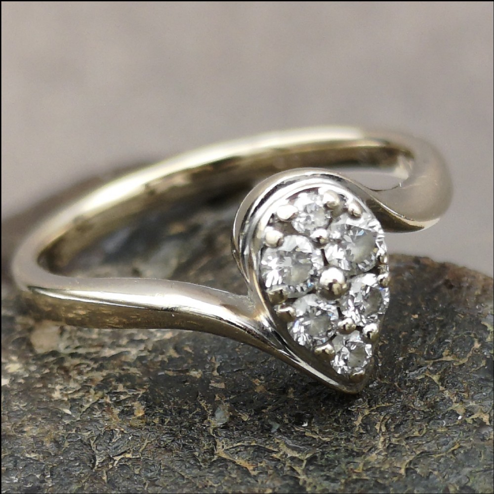 An 18 carat white gold pear shaped diamond cluster ring