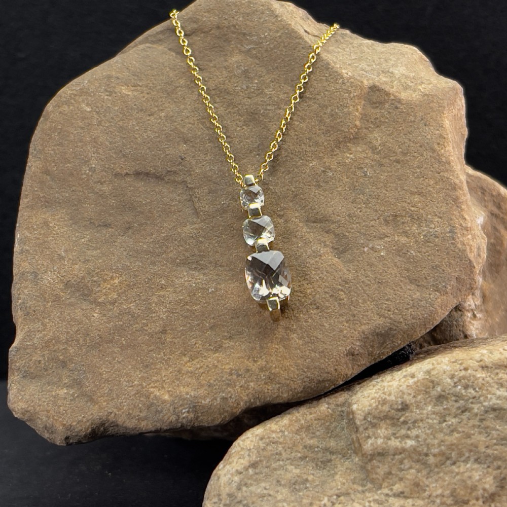 A 9ct yellow gold drop pendant featuring three graduated cushion-cut gemstones on a fine link chain. View II