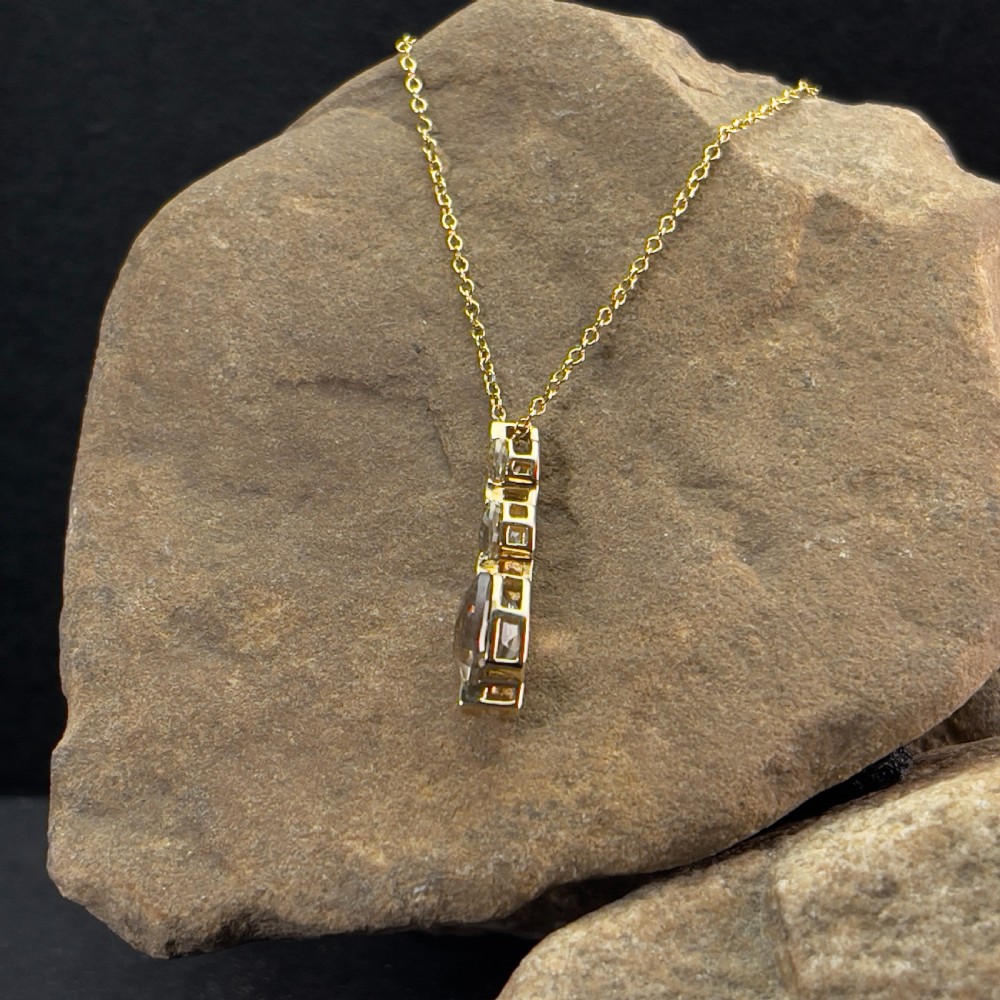 A 9ct yellow gold drop pendant featuring three graduated cushion-cut gemstones on a fine link chain. View III