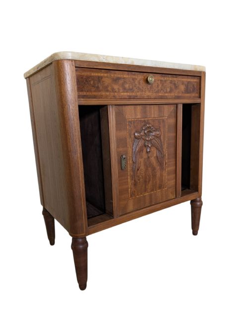 fig 1. An antique walnut bedside cabinet featuring a pale marble top, central carved cupboard door, single drawer, open side compartments, and tapered legs.